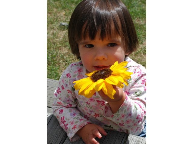 Naomi with a small sunflower